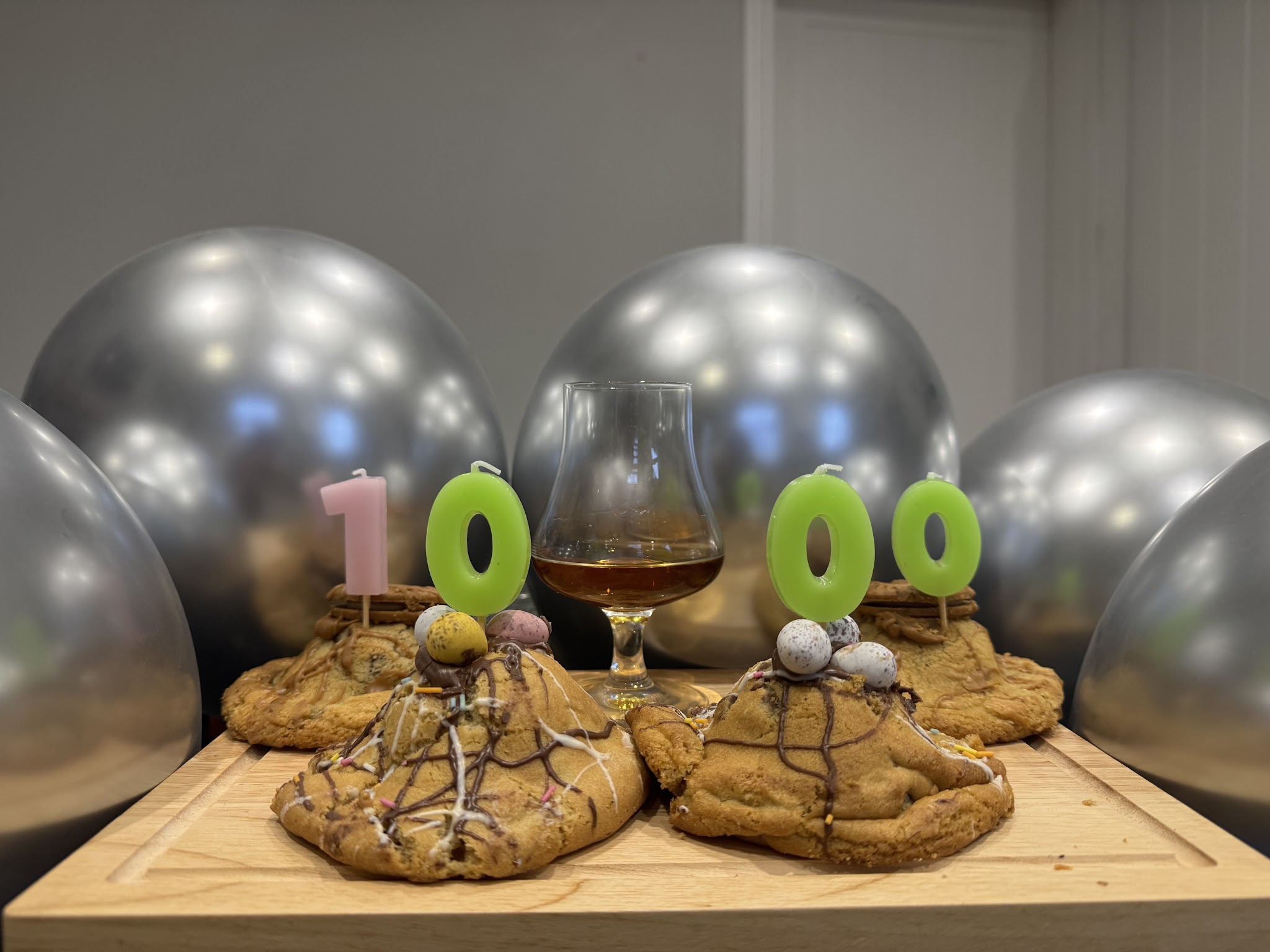 Decorated cookies arranged on a wooden board for a celebration